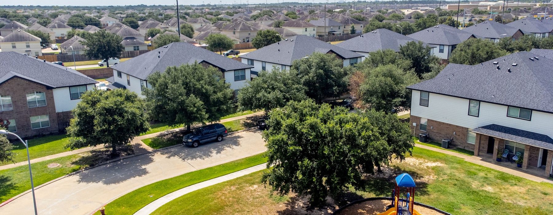 a neighborhood with a car parked in the middle